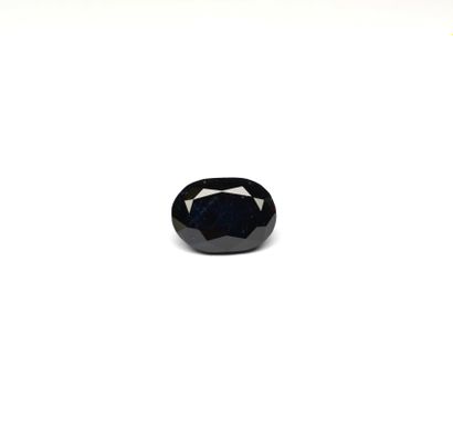 A large oval sapphire on paper weighing 6.68...