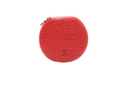 LOUIS VUITTON. Étui rond à bijoux en cuir...