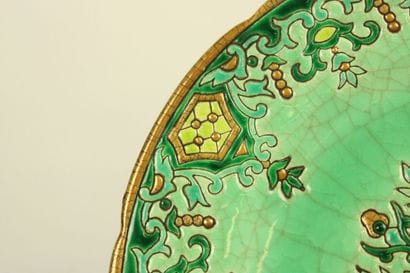 LONGWY. Plate and cup in enamelled earthenware...