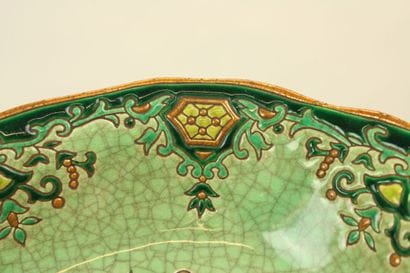LONGWY. Plate and cup in enamelled earthenware...