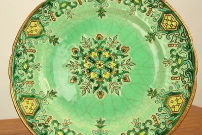 LONGWY. Plate and cup in enamelled earthenware...