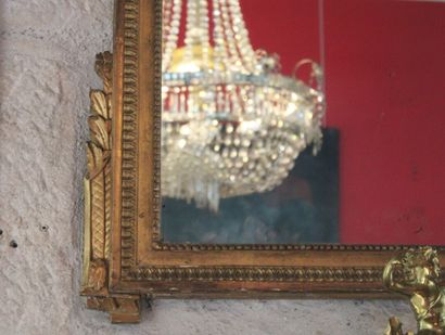 A molded, carved and gilded wood mirror,...