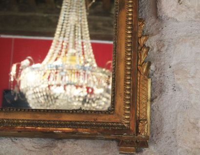 A molded, carved and gilded wood mirror,...