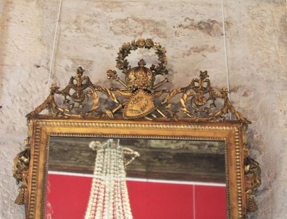 A molded, carved and gilded wood mirror,...