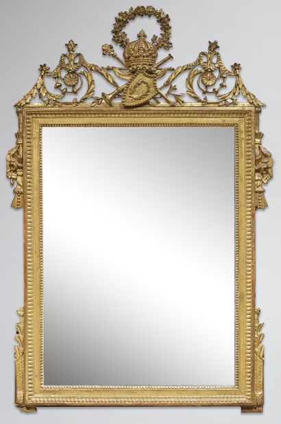 A molded, carved and gilded wood mirror,...