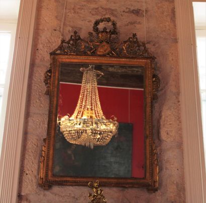 A molded, carved and gilded wood mirror,...