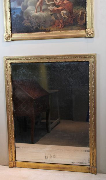 Molded and carved wood trumeau with a mirror...