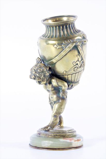 Water-carrying putto in chased and gilded...