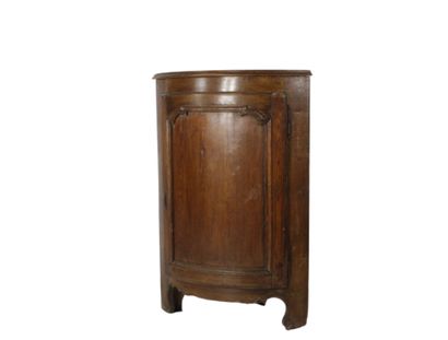 Oak corner cabinet opening with a front door....