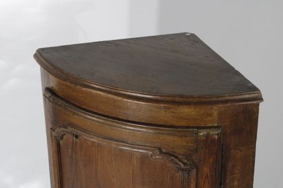 Oak corner cabinet opening with a front door....