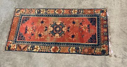 Carpet
Salmon-pink field decorated with geometrically...