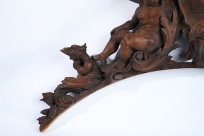 Molded, openwork and carved walnut pediment...
