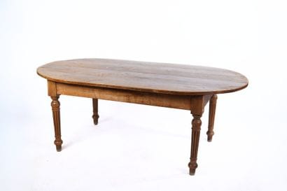 Rare table en noyer à plateau ovale à piètement...