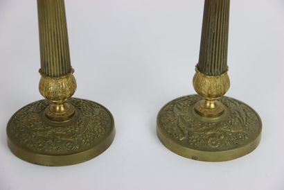 Pair of gilt brass candlesticks. Fluted and...