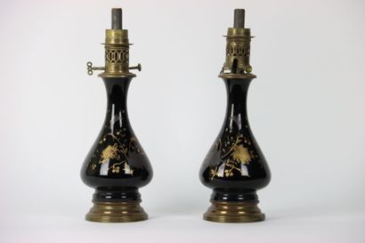 A pair of baluster oil lamps in porcelain...