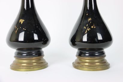 A pair of baluster oil lamps in porcelain...