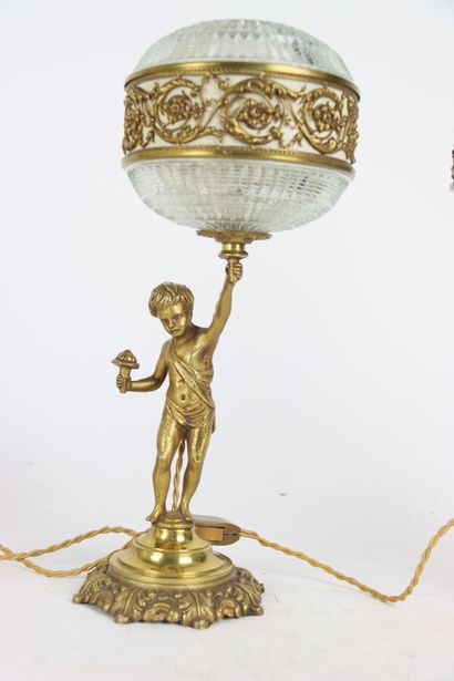 Pair of gilt bronze lamps, the shaft formed...