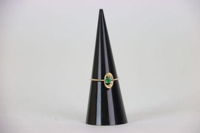 Gold ring set with an emerald and four white...