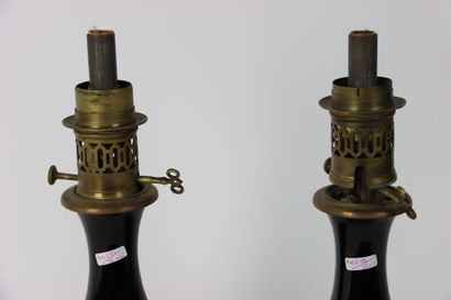 A pair of baluster oil lamps in porcelain...