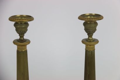 Pair of gilt brass candlesticks. Fluted and...