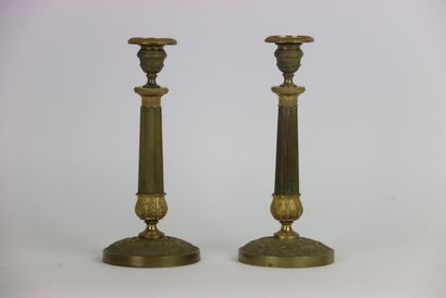 Pair of gilt brass candlesticks. Fluted and...