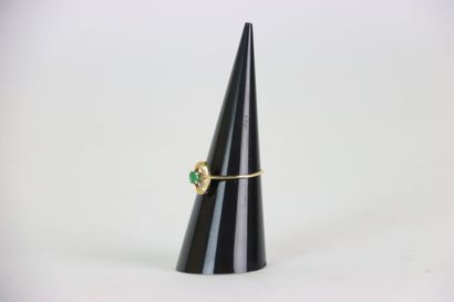 Gold ring set with an emerald and four white...