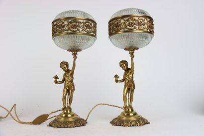 Pair of gilt bronze lamps, the shaft formed...