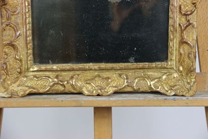Carved and gilded wood mirror, pediment with...