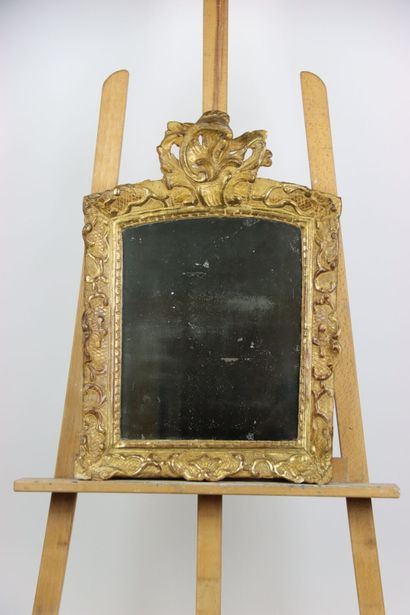 Carved and gilded wood mirror, pediment with...