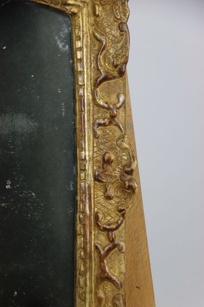 Carved and gilded wood mirror, pediment with...