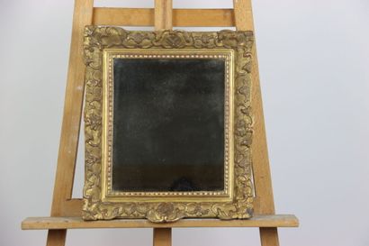 Carved and gilded wood mirror with foliage...