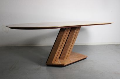 Dining table with oval top resting on a double...