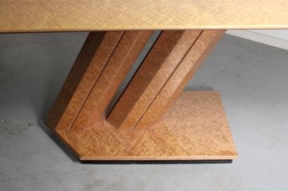 Dining table with oval top resting on a double...