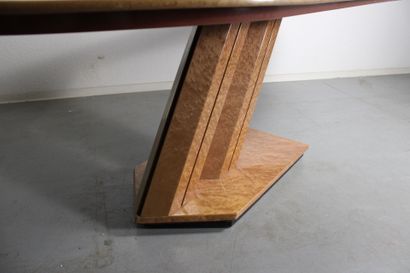 Dining table with oval top resting on a double...