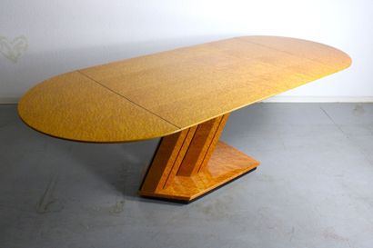 Dining table with oval top resting on a double...