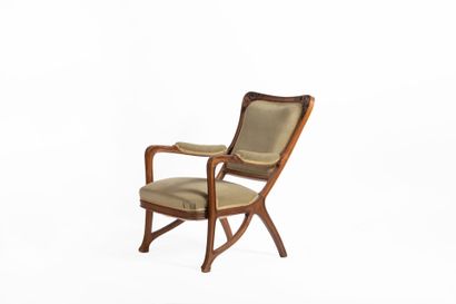 Louis MAJORELLE (1859-1926).
Light wood armchair...