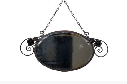 Oval wrought-iron framed mirror with flower...