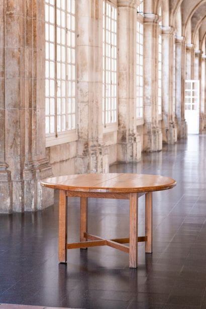 Round oak refectory table resting on four...