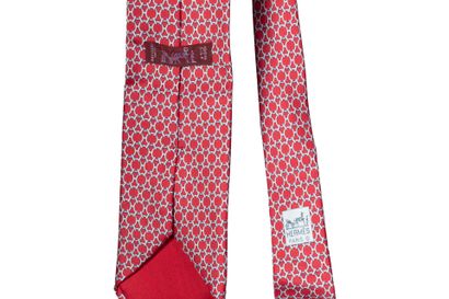 HERMES
Silk tie with interlaced bit pattern.
Used...
