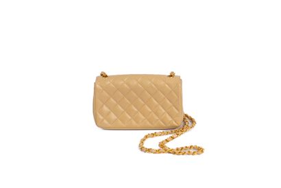CHANEL
Small clutch bag with flap in beige...