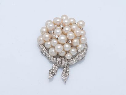 Bouquet brooch tied with a platinum ribbon...