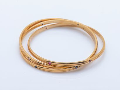 CARTIER
Set of three interlaced joncs bracelets...