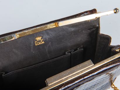 DUC
Stiff bag in chocolate crocodile leather...