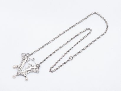 Metal pectoral necklace featuring a pendant...