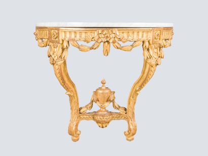 Carved and gilded wood console adorned with...