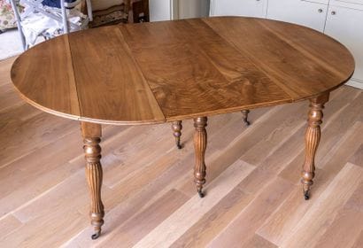 Table ovale à allonges en noyer mouluré et...