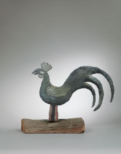Painted tin cockerel mounted on a wooden...