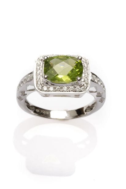 18K white gold ring set with an oval-cut...