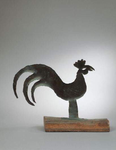 Painted tin cockerel mounted on a wooden...