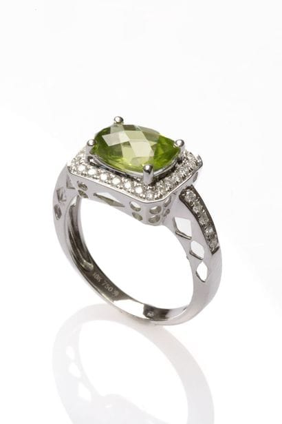 18K white gold ring set with an oval-cut...